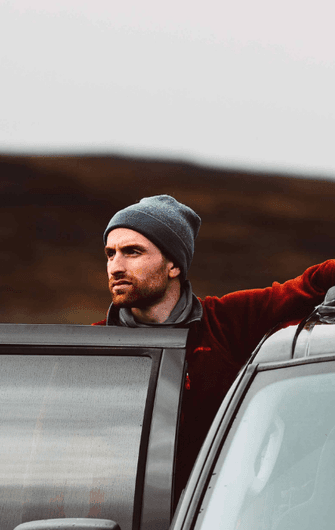 Canva Images Hero Images man enjoying peaceful mountain views in his car website