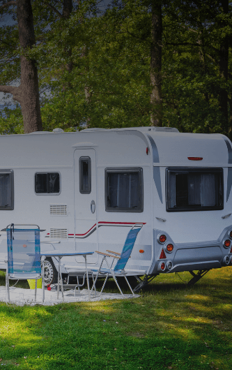 Caravan by lake image website with dark fade added 706 x 530